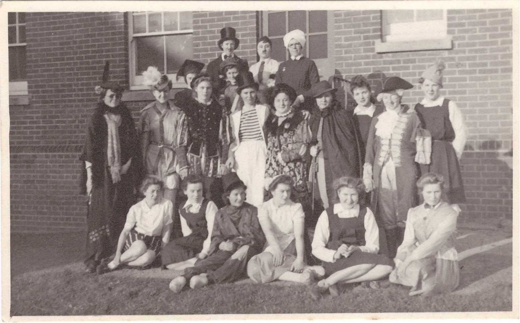 WW2 photo of staff in fancy dress. Brigit Coyle back row wearing a turban